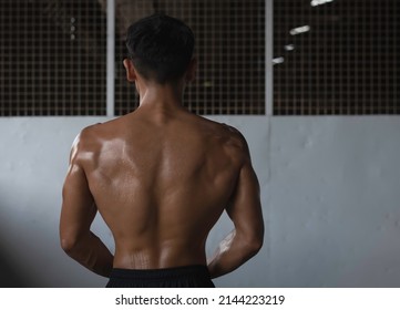 Back Side Of Young Man With Fit And Firm Muscle,sweaty Body,blurry Light Around