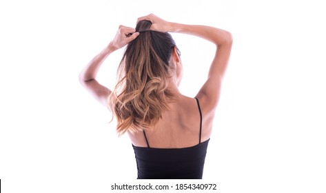 Back Side Of Young Woman With Long Ponytail Isolated On White. Hair Care