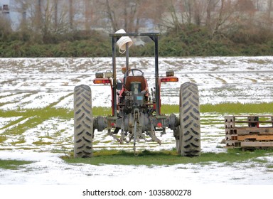 The Back Of A Small Utility Tractor Used For Minor Chores In And Around A Local Farm During The Winter Months. 