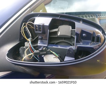 Back Of A Smashed Wing Mirror With Exposed Wires And Mechanisms