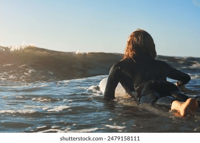 Back, sports and man in ocean for surfing, paddling and balance for professional in training. Beach, water and waves with male surfer for fitness, practice and prepare on surfboard for junior contest - Powered by Shutterstock