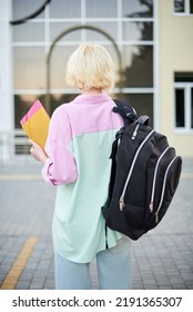 Back Of Student Girl Holding Books And Carry School Bag Walking In School Campus Background, Back To School Concept