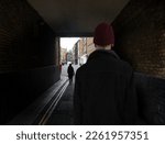 Back Of Suspicious Looking Man In Dark Alley
