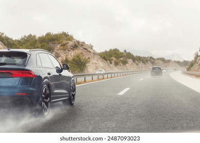 Back tail view of many cars driving fast on wet highway road after rain in Europe. Automobile accident vehicle rush hour collapse. Aquaplaning danger risk. Transportation vacation seasonal stuck - Powered by Shutterstock