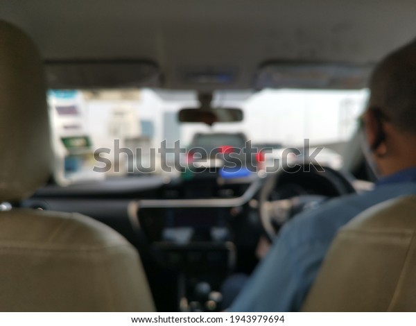 Back of\
Taxi Driver and passenger in side the taxi car during go to\
destination with traffic jam in\
Bangkok,Thailand.