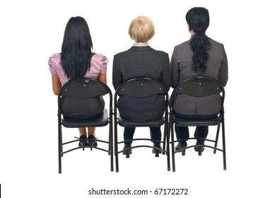 Back Of Three Business Women Sitting On Chairs At  Presentation Isolated On White Background