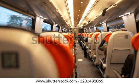 Back of train perspective interior highspeed transportation corridor. Passengers seated inside transport