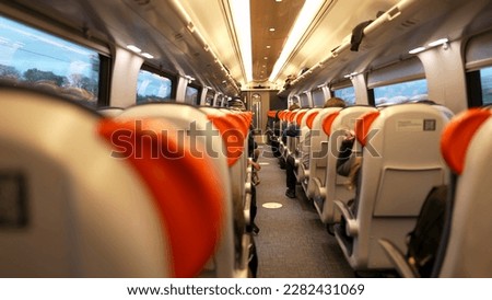 Back of train perspective interior highspeed transportation corridor. Passengers seated inside transport