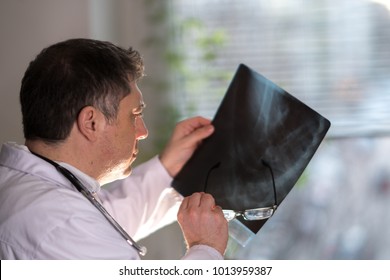 Back Turned Concentrated Radiologist Reading X-ray Images