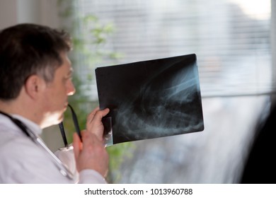 Back Turned Concentrated Radiologist Reading X-ray Images