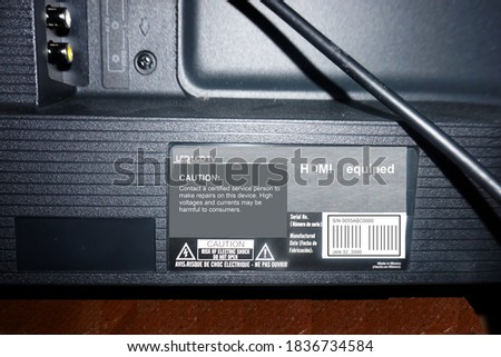 back of a tv showing where the serial number is located and any cautionary statements mandated by the government.