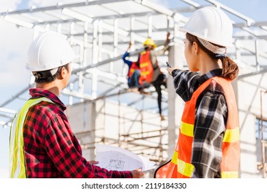 Back Two Architect And Client Discussing Help Create Plan With Blueprint Home Building At Construction Site. Asian Engineer Foreman Worker Man And Woman Meeting Talking On Drawing Paper Project