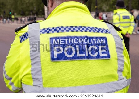 Back of the vest of a London Metropolitan Police Officer in Hi-visibility Uniform
