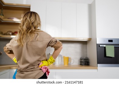 Back View Of Adult Woman Getting Ready For Kitchen Cleaning