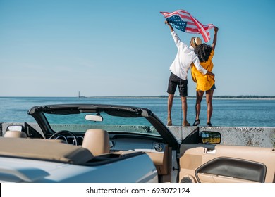 back view of african american couple with american flag standing on parapet together - Powered by Shutterstock