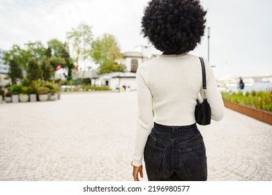 Back View Of African Woman Walking In City