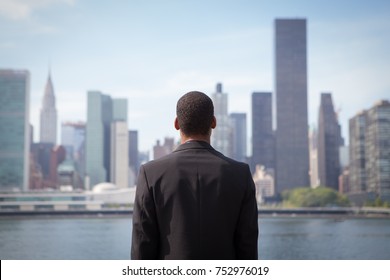 Back View Of Ambitious Young African American Business Man Looking At NYC Skyline, Photographed In NYC In September