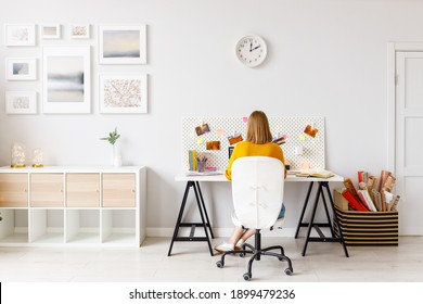 Back View Of Anonymous Woman During   Work While Sitting At Desk In Home Office