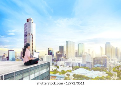 Back View Of Asian Business Woman Working With Laptop On The Rooftop