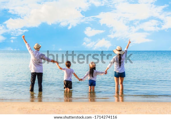 Back view of asian family consist dad, mom, son and daughter standing ...