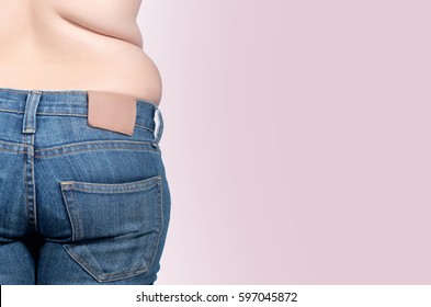 back view. asian fat women has overweight. she shows excess fat of the waist. isolated on violet background. she wants lose weight. concept of surgery and subcutaneous fat breakdown.