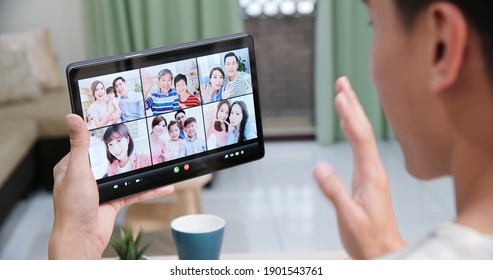 Back View Of Asian Man Has Video Chat With Family And Friends By Digital Tablet At Home Happily