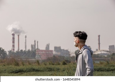 Back View Of Asian Man Look Something And Wears Protective N95 Mask Against Air Pollution In Front Of Factory