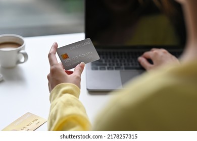 Back View Of Asian Woman In Casual Outfit Entering Typing Credit Card Number On Laptop To Purchase Items From An Online Store, Order Food, Pay Bills.