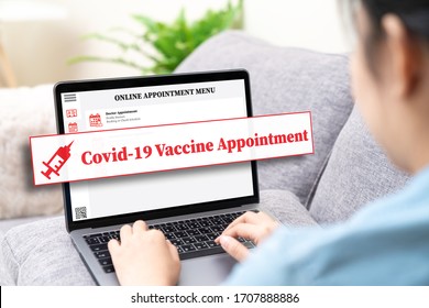 Back view of asian woman using online health appointment, booking or reserve coronavirus or covid-19 vaccine in concept social distance healthcare in quanrantine people at home using laptop computer.