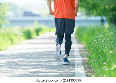 Back View Of Asian Young Man Running Outdoor, No Face