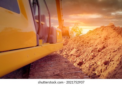 Back view backhoe working by digging soil at the construction site. Crawler excavator digging on demolition site. Excavating machine. Earthmoving equipment. Excavation vehicle. Construction business.