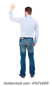 Back View Of Beautiful Business Man Welcomes. Businessman In White Shirt Cheerfully Waving His Hand In Greeting.