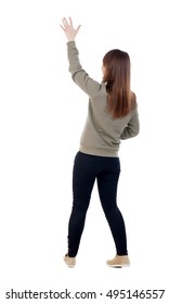 Back View Of Beautiful Woman Welcomes. Young Teenager Girl In Dress Hand Waving From. Rear View  People Collection.  Backside View Of Person.  Isolated Over White Background. A Girl In A Gray Jacket