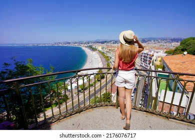 Back view of beautiful young woman holding hat enjoying view of the cityscape of Nice, France - Shutterstock ID 2176076717