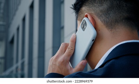 Back view from behind unrecognizable man in formal suit businessman leader salesman talking mobile phone outdoor in city remote distant virtual talk with smartphone cell conversation negotiate outside - Powered by Shutterstock