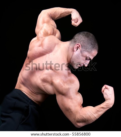 Back view of a body builder, isolated on black