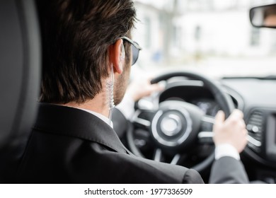 Back View Of Bodyguard Driving Modern Automobile