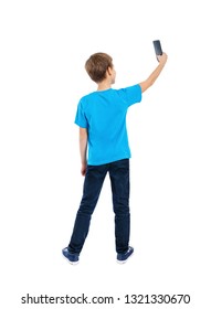 Back View Of Boy In T-shirt And Jeans Using A Mobile Phone Isolated On White Background