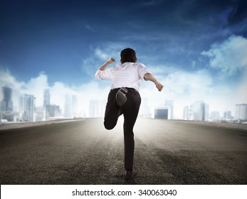 Back View Of Business Man Running To The City