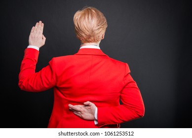 Back View Of Business Woman Taking Fake Oath On Black Background