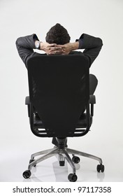 Back View Of Businessman Relaxing In Black Chair