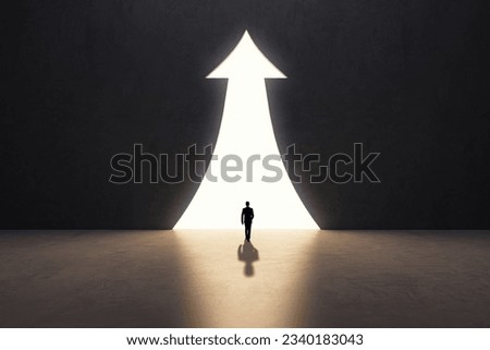 Back view of businessman silhouette in abstract concrete interior with upward arrow opening. Success, financial growth and future concept