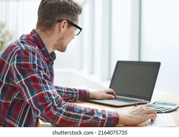 Back view businessman sitting in front laptop screen  Man typing modern laptop in an office  Young student typing computer sitting at wooden table 