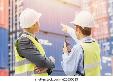 Back view of businessman with staff in logistic, export, import industry checking shipping cargo container freight in. - Shutterstock ID 628850813