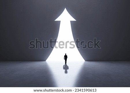 Back view of businessperson silhouette in abstract concrete interior with upward arrow opening. Success, financial growth and future concept