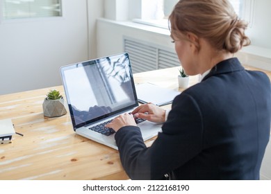 Back View. Businesswoman Is Typing On Laptop For Check Email, Preparation Of Presentation In Meeting, Get Information For Or Operation Of Internet Banking