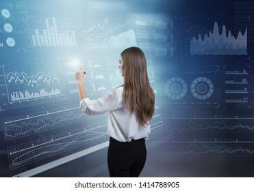 Back View Of Businesswoman Working With Virtual Panel