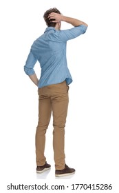 Back View Of Casual Guy Scratching Head, Trying To Solve Difficult Problems, Isolated On White Background, Full Body