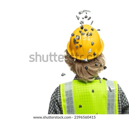 Back view caucasian blonde hair construction industrial worker wear yellow hard hat safety vast. Gravel stone sands supply fall down into head of engineer as accident. White background isolated