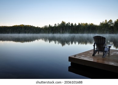 Back view of a chair over a dock in a foggy lake - Powered by Shutterstock